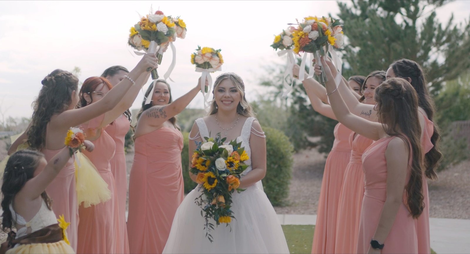 bride holding bouquet with bridesmaids