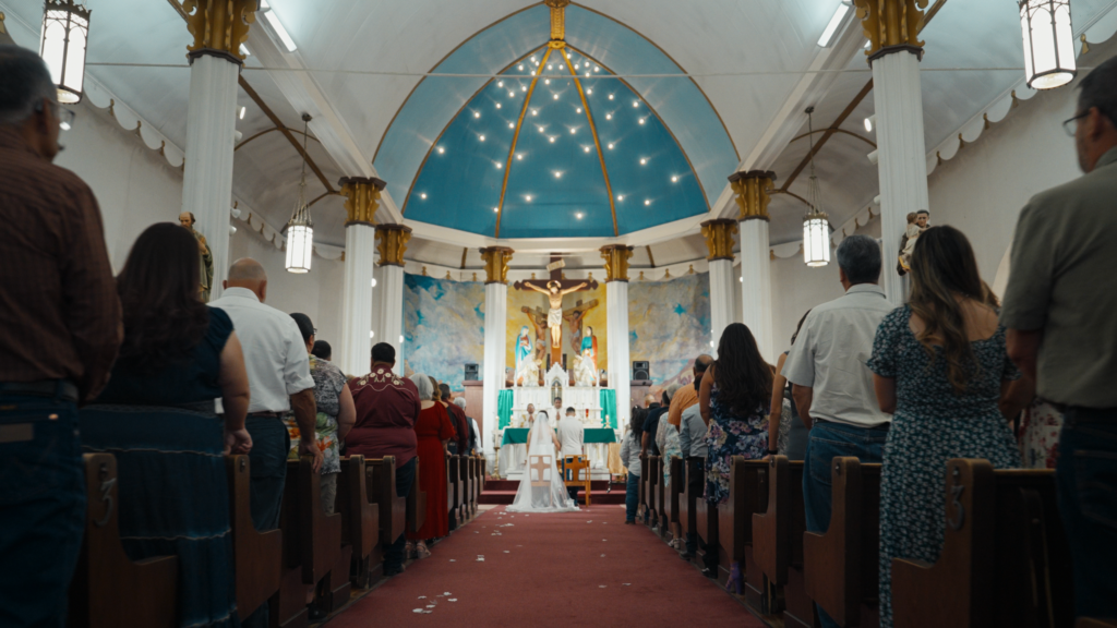 Bride and groom at the altar during their Catholic wedding ceremony