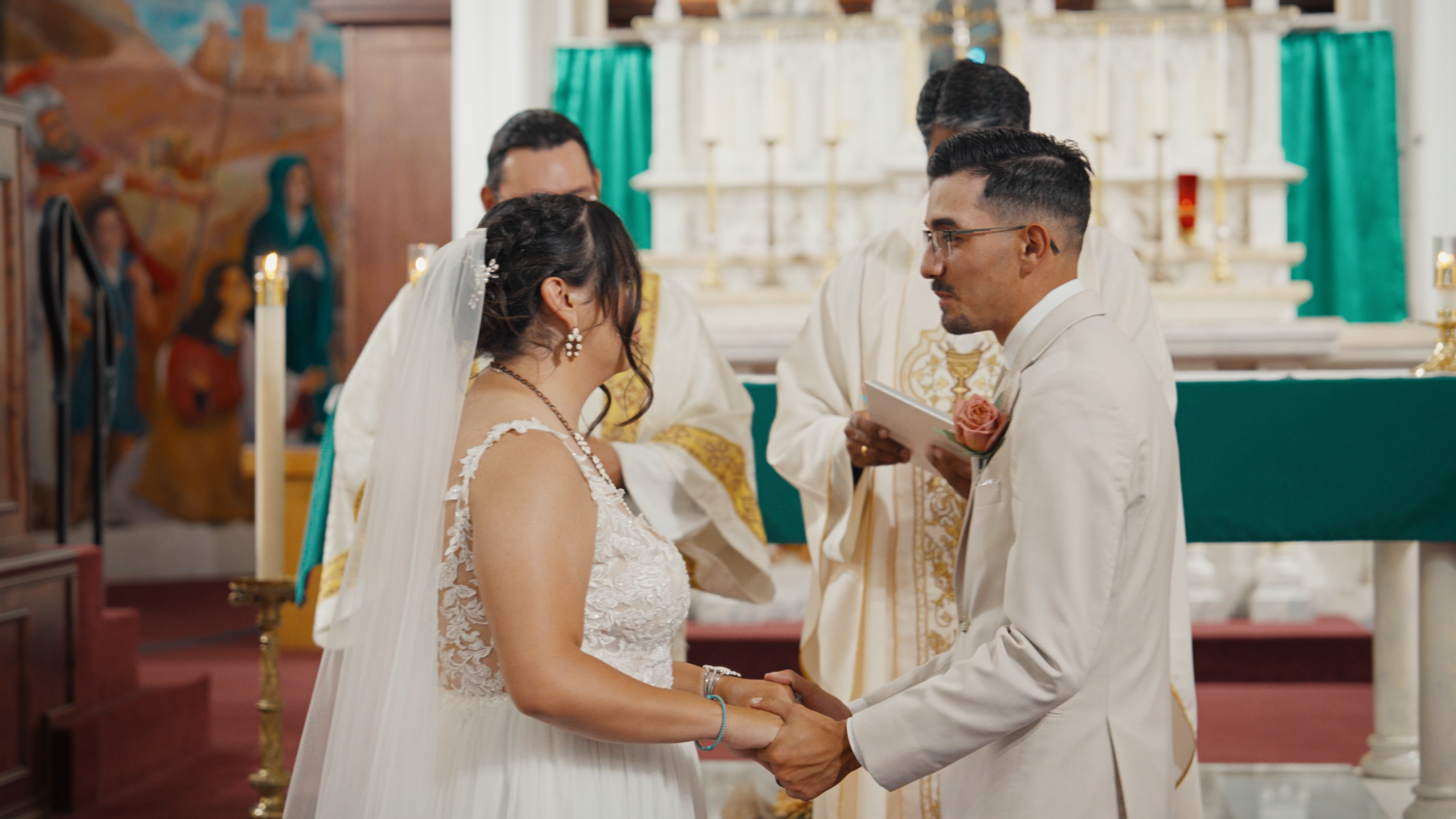 Bride and groom holding hands during their wedding ceremony