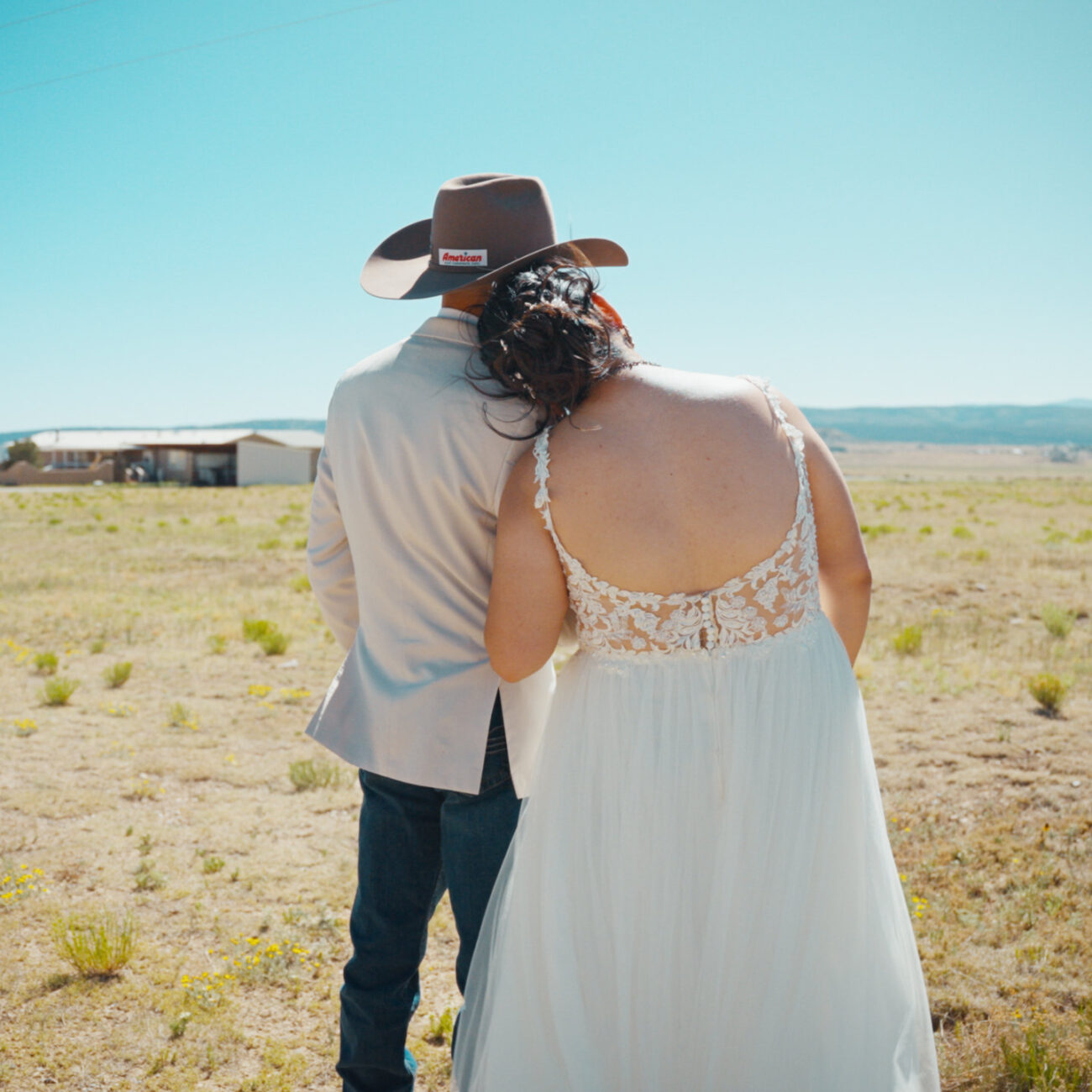 Bride and groom embracing during an outdoor desert wedding