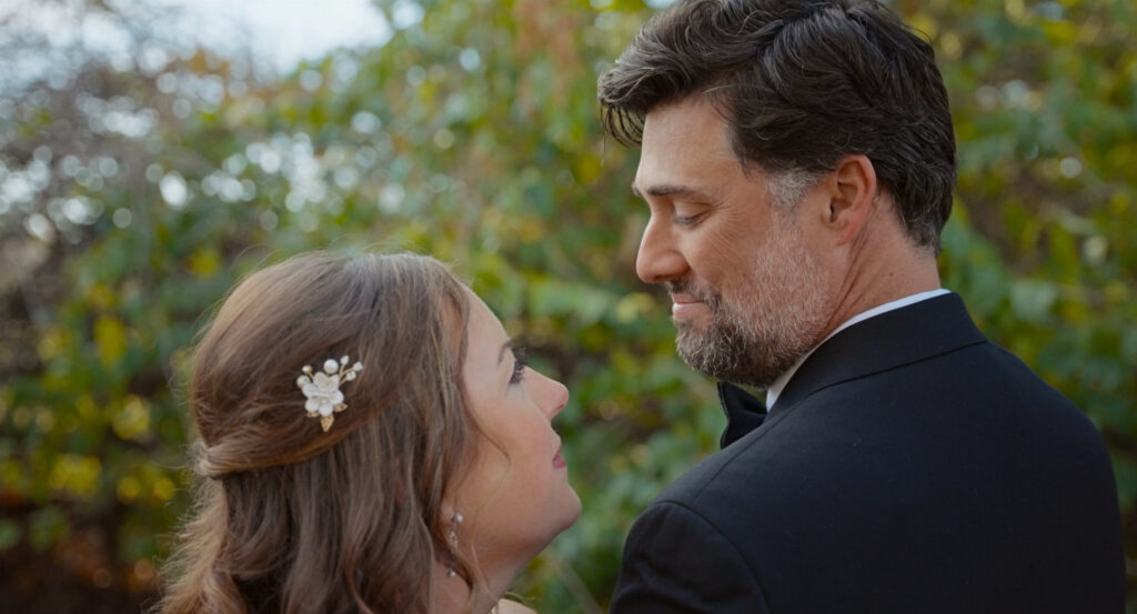 Bride and groom sharing an intimate moment during outdoor wedding portraits