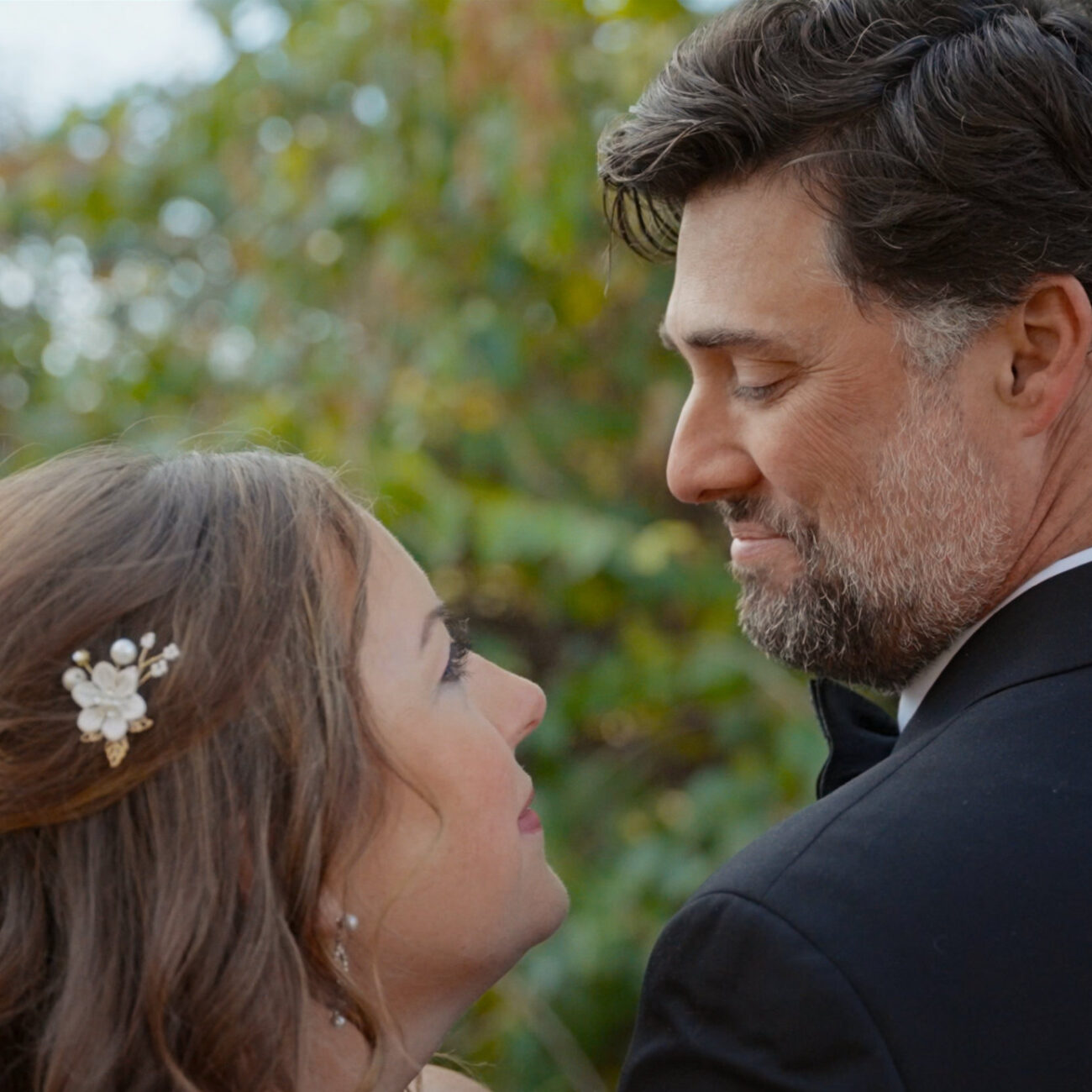 Bride and groom sharing an intimate moment during outdoor wedding portraits